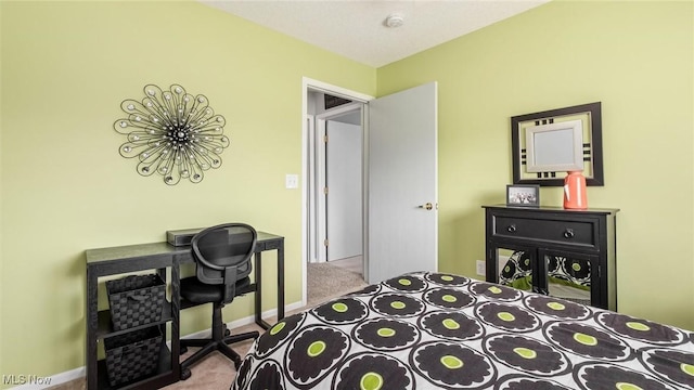 bedroom with light carpet and baseboards