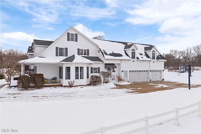 view of front of home with a garage, covered porch, and fence