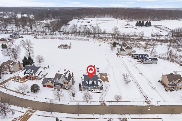 snowy aerial view with a residential view