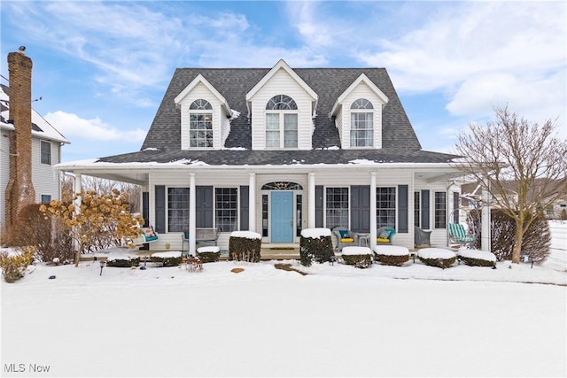 view of front of property with covered porch and roof with shingles