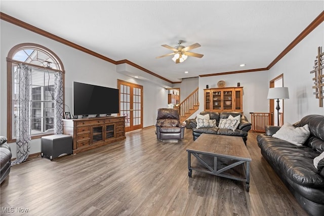 living room featuring french doors, stairway, wood finished floors, and baseboards