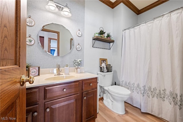 full bath featuring toilet, ornamental molding, wood finished floors, and vanity