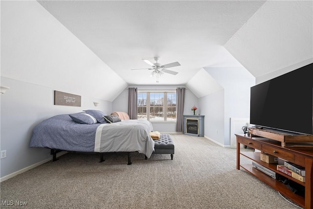 bedroom with a ceiling fan, carpet flooring, vaulted ceiling, and baseboards