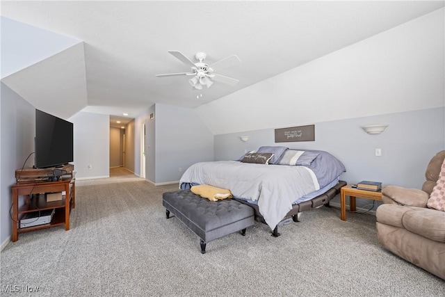 bedroom featuring light carpet, vaulted ceiling, a ceiling fan, and baseboards