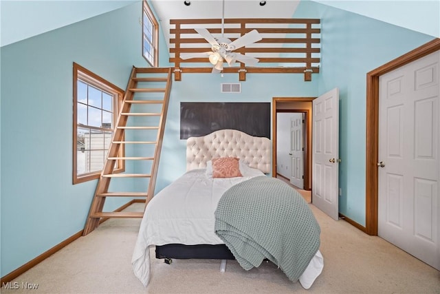 bedroom featuring high vaulted ceiling, light colored carpet, visible vents, and baseboards