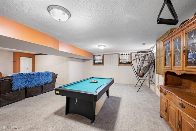 rec room featuring pool table, a textured ceiling, and light colored carpet