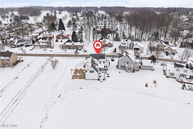 snowy aerial view featuring a residential view