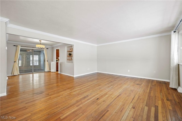 unfurnished living room with light wood-type flooring, baseboards, and crown molding