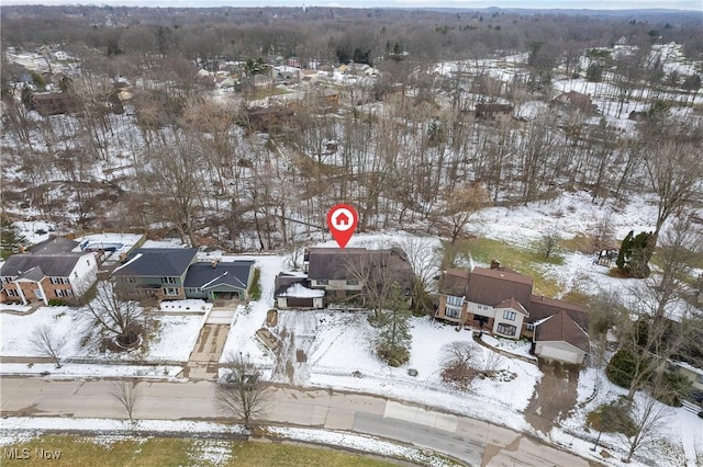 snowy aerial view featuring a residential view