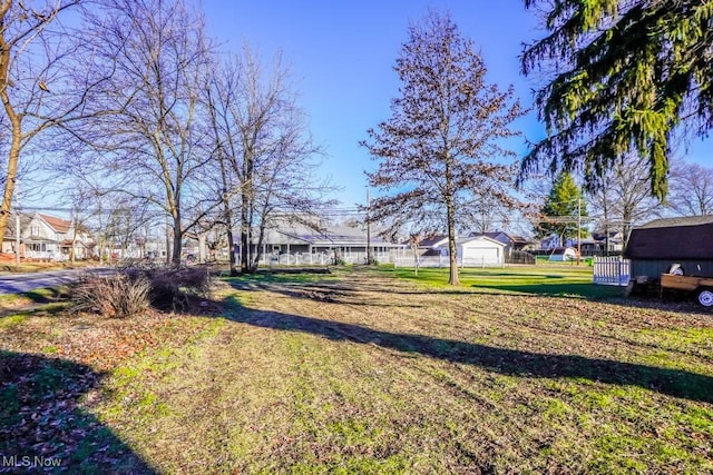 view of yard featuring a residential view and fence