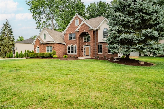 view of front of home featuring a front yard and brick siding