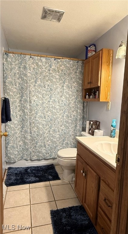 full bath with visible vents, toilet, vanity, a textured ceiling, and tile patterned floors