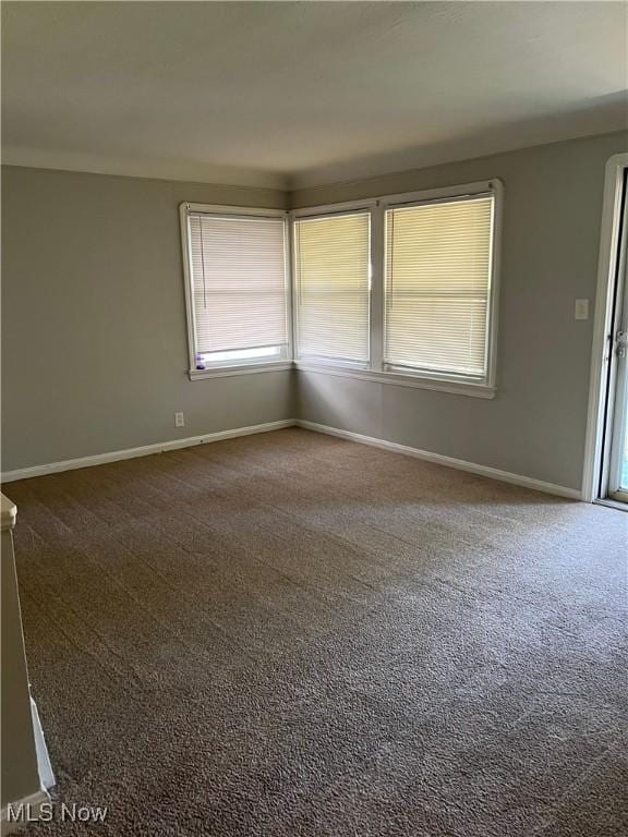 carpeted spare room with baseboards