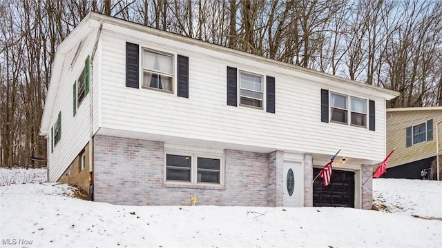 view of front of house with a garage and brick siding