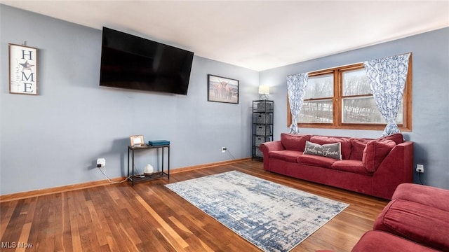 living area with wood finished floors and baseboards