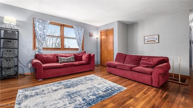 living area featuring wood finished floors and baseboards