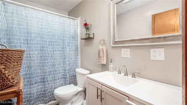 bathroom featuring toilet and vanity