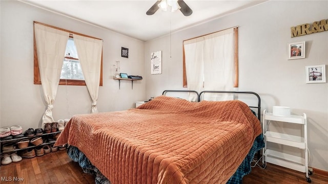 bedroom featuring a ceiling fan and dark wood finished floors