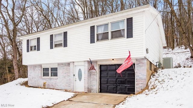 view of front of property with concrete driveway, brick siding, and an attached garage