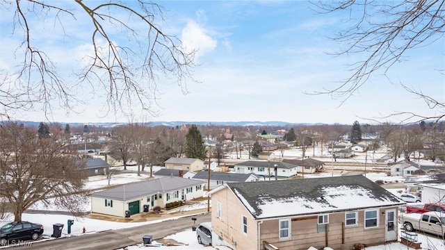 snowy aerial view with a residential view