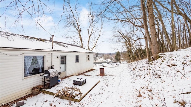 yard layered in snow featuring a garage