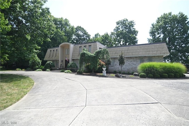 view of front property with mansard roof