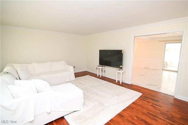 living room with dark wood-style floors, ornamental molding, and baseboards