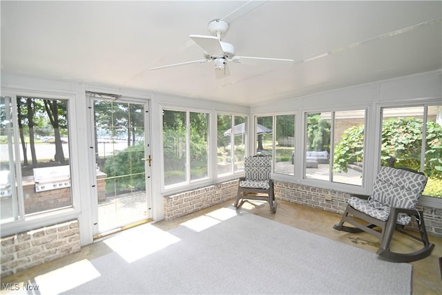 unfurnished sunroom featuring lofted ceiling and ceiling fan