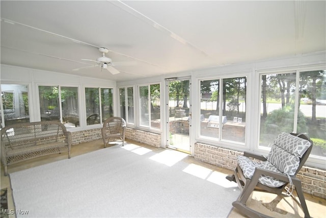 unfurnished sunroom featuring ceiling fan and vaulted ceiling