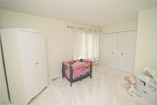 sitting room featuring visible vents and light colored carpet