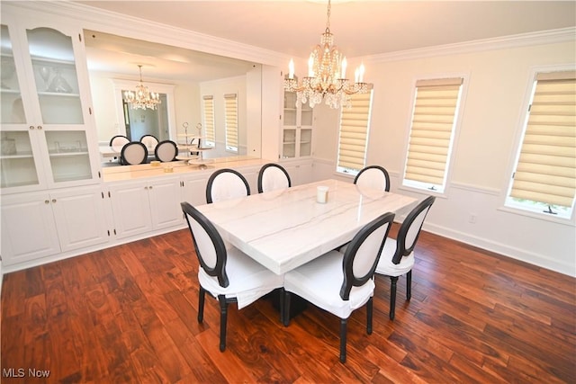 dining room with a chandelier, dark wood finished floors, baseboards, and ornamental molding