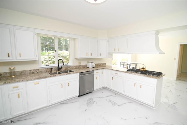 kitchen with appliances with stainless steel finishes, marble finish floor, white cabinetry, and a sink