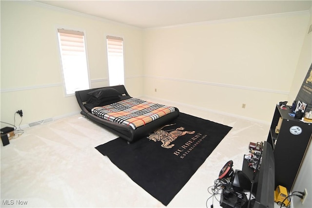 carpeted bedroom with visible vents, ornamental molding, and baseboards