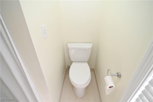 bathroom with toilet and tile patterned floors