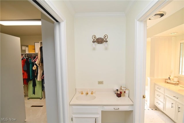 full bath with visible vents, ornamental molding, a walk in closet, and vanity