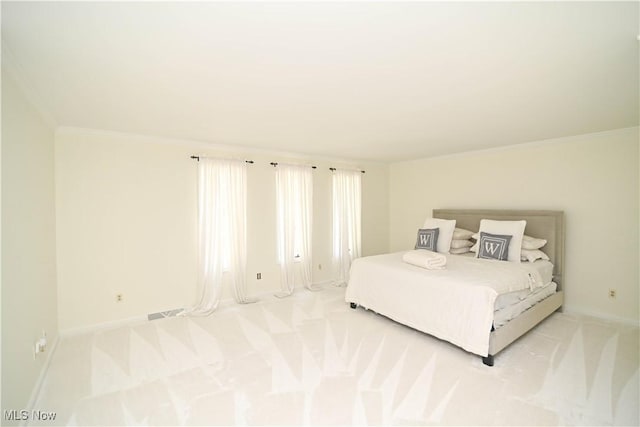 bedroom with light carpet, baseboards, and ornamental molding