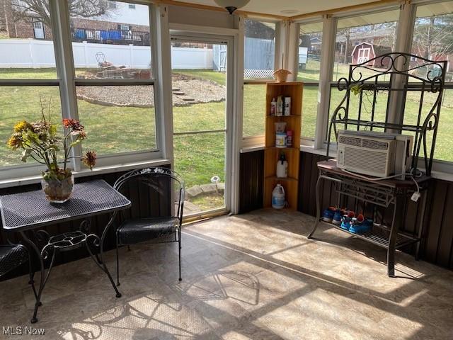 sunroom with a healthy amount of sunlight and cooling unit