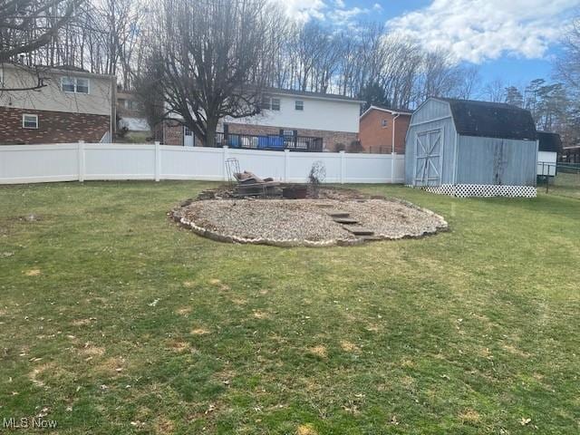 view of yard featuring an outbuilding, a storage unit, and a fenced backyard