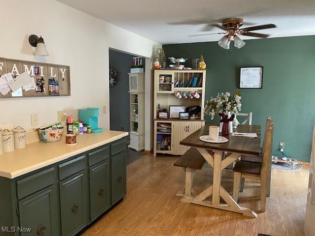 dining room with light wood-type flooring and a ceiling fan