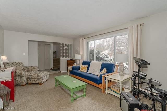 living room featuring stairway and carpet flooring