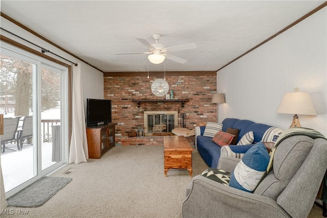 carpeted living room featuring a brick fireplace, visible vents, a ceiling fan, and crown molding