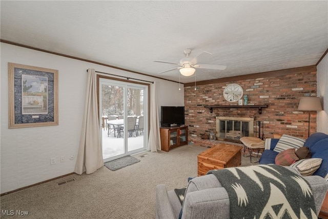 carpeted living room with a fireplace, visible vents, and crown molding