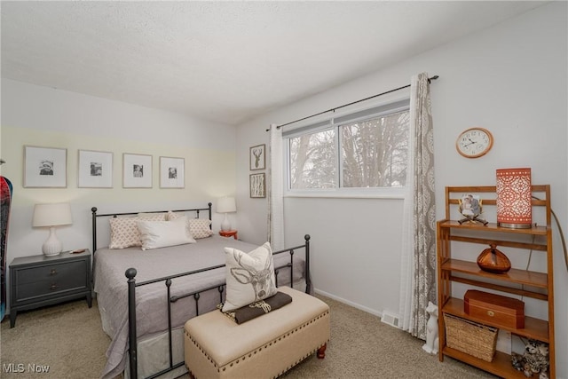 bedroom with baseboards and light colored carpet