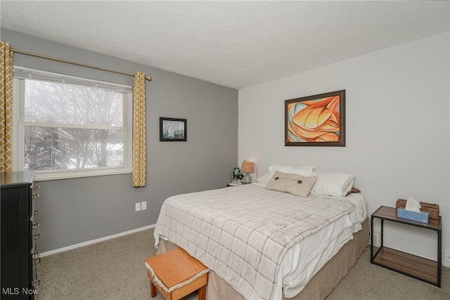 bedroom featuring baseboards, a textured ceiling, and light colored carpet