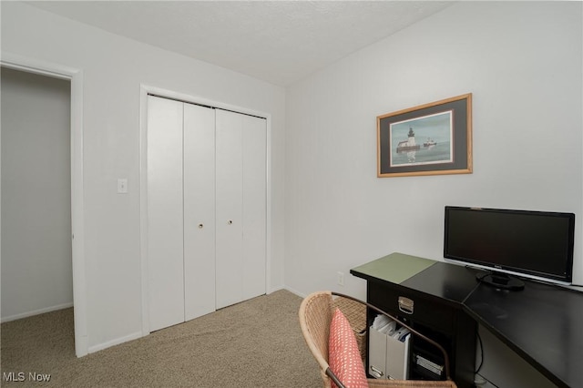 home office with carpet floors and baseboards