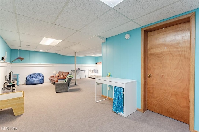 rec room with a paneled ceiling and light colored carpet