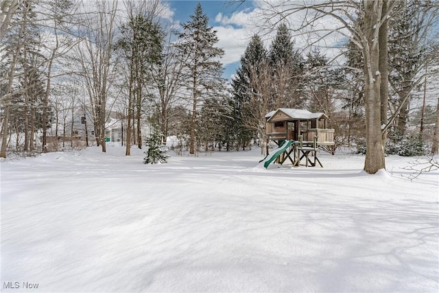 yard layered in snow featuring playground community