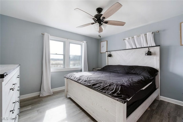 bedroom featuring dark wood-style floors, ceiling fan, and baseboards