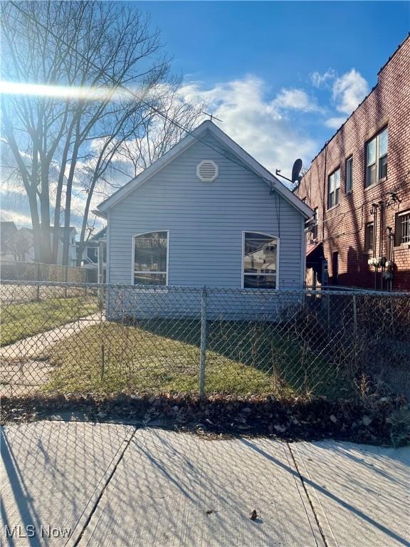 view of home's exterior with fence private yard and a lawn