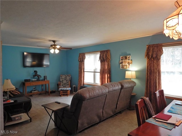 living room with ornamental molding, carpet, and ceiling fan